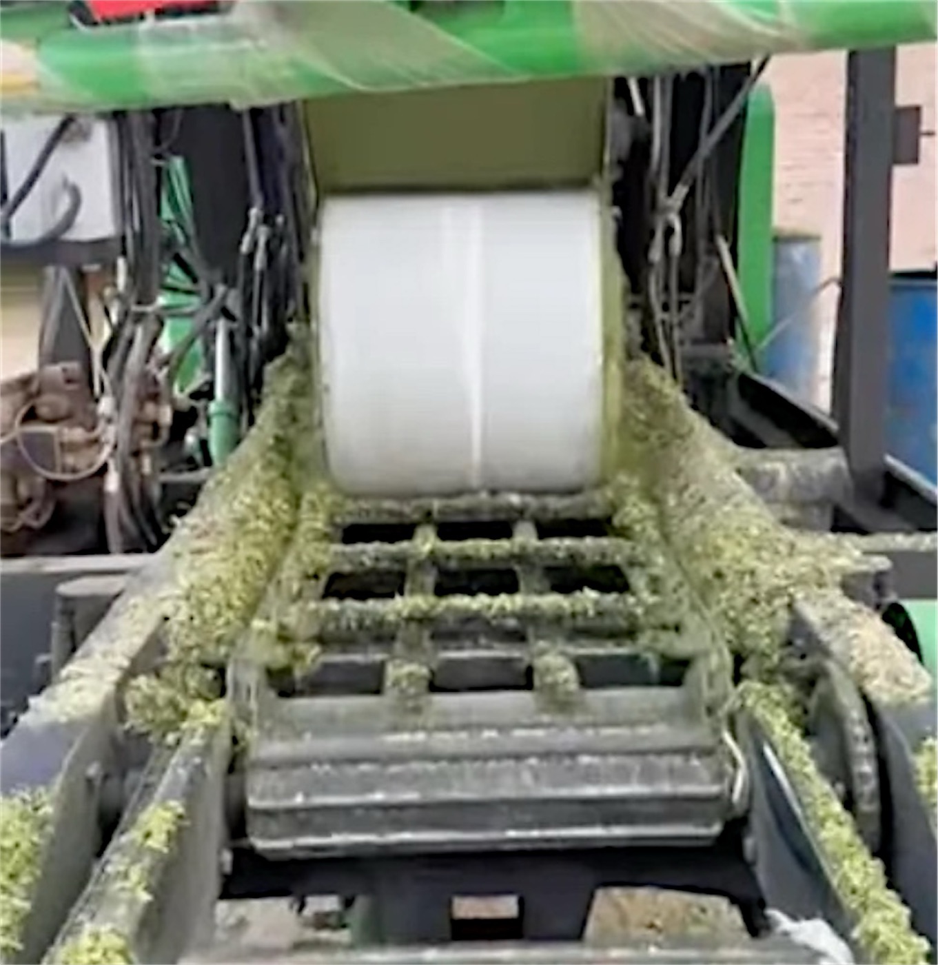 The baler wrapping a fresh bale of chopped maize