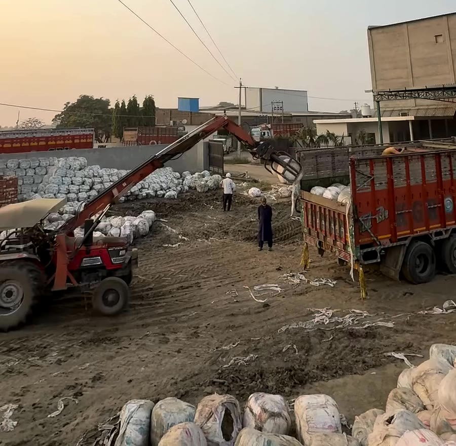 A bale grab loading a truck at the busy Bhadson yard